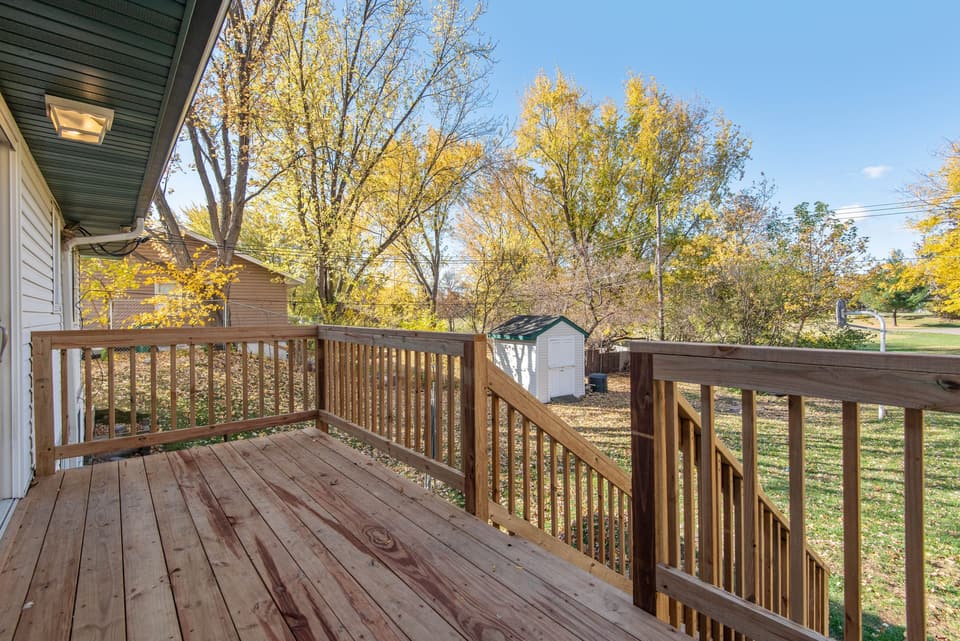 Wooden deck overlooking an autumn backyard