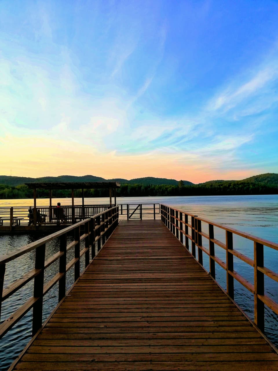 Dock with railings at sunset