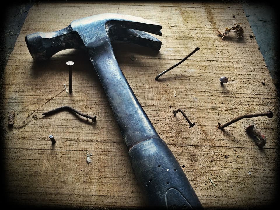 Hammer and nails on a timber board