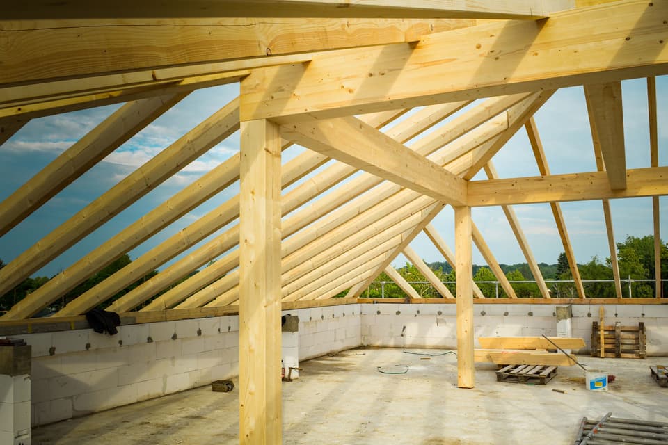 New timber roof framing against the sky