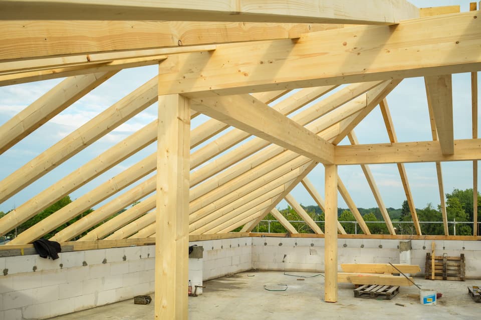 New timber roof framing against the sky
